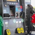 Gas pump with green diesel and red gasoline nozzles