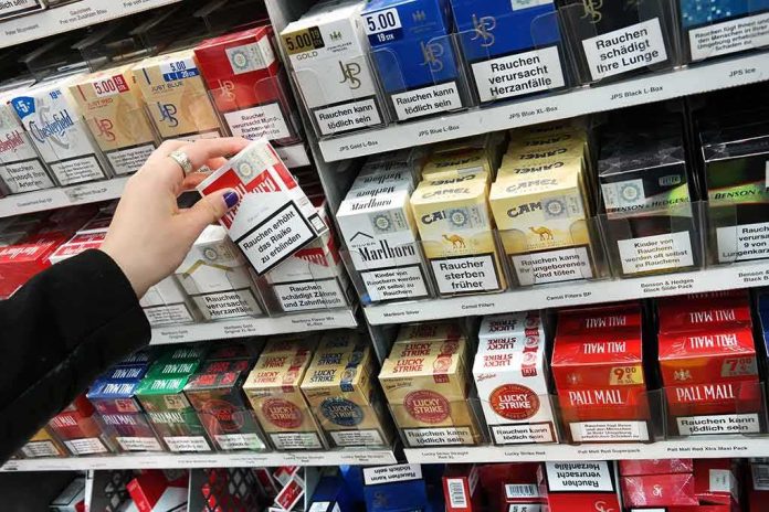 Hand selecting a pack of cigarettes from a store shelf
