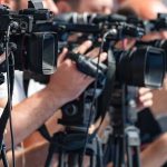 Army Star Exposed: Child Rape Horror television cameras on tripods at a media event