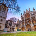 Gothic cathedral facade at dusk with illuminated rose window