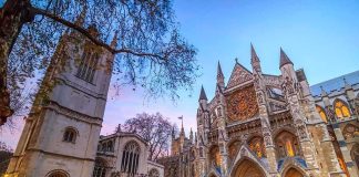 France’s Catholic Faith Engine STALLS Gothic cathedral facade at dusk with illuminated rose window
