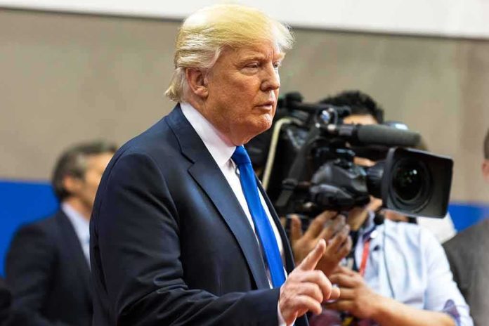 shutterstock_448013455 Donald Trump speaking with media cameras in the background
