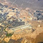 Aerial view of desert city with airport and highways