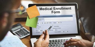 Laptop displaying a medical enrollment form with two people reviewing it
