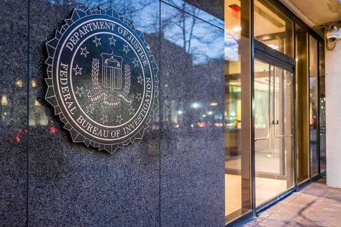 FBI emblem on a stone wall beside a glass entrance