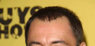 Smiling man with short hair and stubble