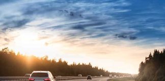 Cars driving on a highway at sunset