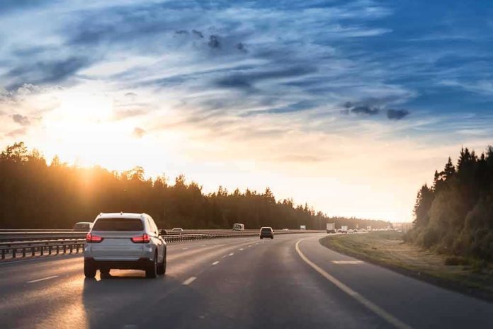 Cars driving on a highway at sunset