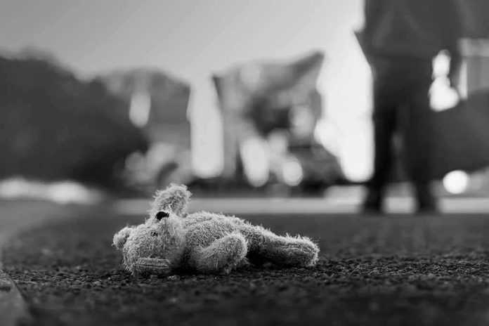 Stuffed toy lying on pavement in black and white