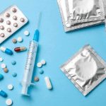 Contraceptives and medications on blue background