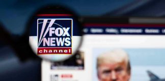 magnified fox news logo over blurred website