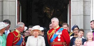 Elizabeth II with Charles, Prince of Wales, and Prince Andrew on balcony; Meghan, Duchess of Sussex, and Prince Harry nearby