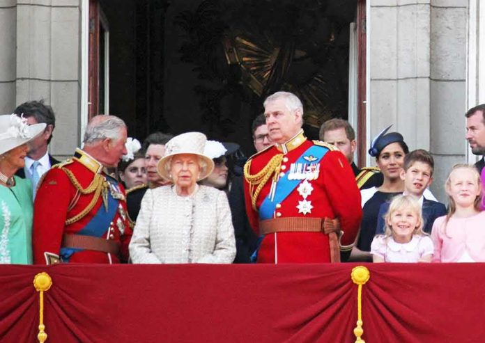 Elizabeth II with Charles, Prince of Wales, and Prince Andrew on balcony; Meghan, Duchess of Sussex, and Prince Harry nearby