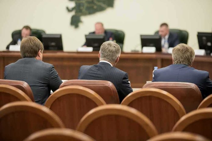 Business meeting attendees facing a panel in a conference room
