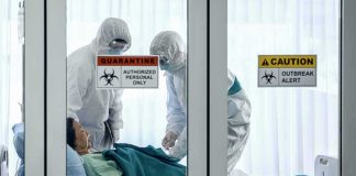 10,000+ Ebola Cases and SPREADING Healthcare workers in hazmat suits treat a patient in a quarantine room