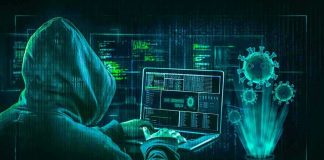 Hacker in hoodie using laptop with digital virus graphics