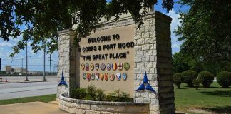 stone entrance sign with military unit emblems