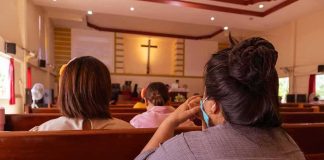 Democrat Pastor’s ‘White PRIVILEGE’ Sermon Resurfaces people seated in church pews facing a cross