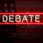 Neon sign reading debate on a brick wall