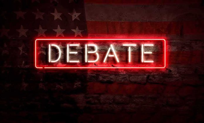 shutterstock_1790572004 Neon sign reading debate on a brick wall