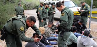 Border Czar’s 2028 WARNING About Democrats law enforcement officers process a seated group outdoors
