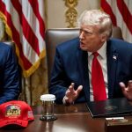 Donald Trump speaks at a meeting table beside Marco Rubio